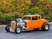 AUT 26 RK2686 01
1934 Plymouth 5-Window Coupe Hot Rod Orange 3/4 Front View On Pavement By Trees