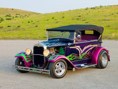 AUT 26 RK2703 01
1931 Ford Model A Deluxe Phaeton Hot Rod Purple Green And Pink Flames 3/4 Front View On Pavement By Hills