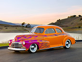 AUT 26 RK2724 01
1948 Chevrolet Coupe Hot Rod Orange And Pink 3/4 Front View On Pavement By Hills And Lake