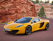 AUT 28 BK0002 01
2013 McLaren 12C Spider Yellow 3/4 Front View On Road By Red Rock And Trees