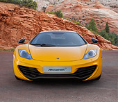 AUT 28 BK0003 01
2013 McLaren 12C Spider Yellow Front View On Road By Red Rock And Trees