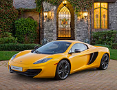 AUT 28 BK0004 01
2013 McLaren 12C Spider Yellow 3/4 Front View On Brick By House