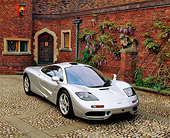 AUT 28 RK0029 01
McLaren F-1 Silver 3/4 Front View On Stone Pavement By Brick House