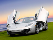 AUT 28 RK0138 01
2012 McLaren MP4-12C Prototype Silver 3/4 Front View On Grass By Building