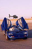AUT 28 RK0119 01
1993 Mclaren F1 XP4 Blue 3/4 Front View Doors Open On Pavement Helicopter In Background