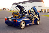 AUT 28 RK0120 01
1993 Mclaren F1 XP4 Blue 3/4 Rear View Doors Open On Pavement By Hangar