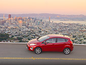 AUT 29 BK0031 01
2011 Ford Fiesta Red Profile View On Road By San Francisco Skyline