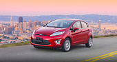 AUT 29 BK0032 01
2011 Ford Fiesta Red 3/4 Front View On Road By San Francisco Skyline
