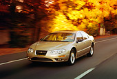 AUT 29 RK0150 07
1999 Chrysler 300M Champagne In Motion 3/4 Front View On Road By Trees
