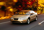 AUT 29 RK0150 08
1999 Chrysler 300M Champagne In Motion 3/4 Front View On Road By Trees