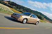 AUT 29 RK0440 01
1999 Pontiac Grand Am Gold Side 3/4 View On Road In Motion