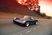 AUT 29 RK0508 03
2000 Ultima GTR Blue 3/4 Front View On Road In Motion By Trees Filtered