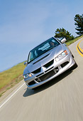 AUT 29 RK0638 24
2003 Mitsubishi Lancer Evolution VIII Silver Slanted 3/4 Front View On Road In Motion