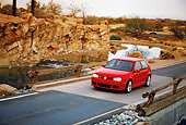 AUT 29 RK0676 06
2005 Volkswagen R32 Golf Red 3/4 Front View Crossing Bridge By Rocks Filtered