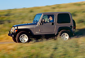 AUT 29 RK0702 01
2004 Jeep Wrangler Rubicon Light Khaki 3/4 Side View On Hill In Motion