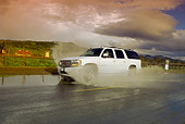 AUT 29 RK1164 01
2005 GMC Yukon XL Denali White 3/4 Side View On Wet Road In Motion