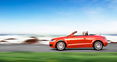 AUT 29 RK1468 01
2008 Audi TT Convertible Red Profile View Driving By Beach