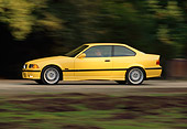 AUT 29 RK0015 05
1995 BMW M3 Yellow 3/4 Front View On Road In Motion
