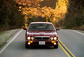 AUT 29 RK0048 20
1998 Jaguar XJ8 Red Head On View On Road In Motion By Trees