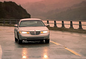 AUT 29 RK0068 04
1998 Lincoln Town Car Silver 3/4 Front View On Wet Road In Motion