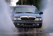 AUT 29 RK0102 01
1998 Lincoln Navigator Green Splashing Water Head On View In Motion