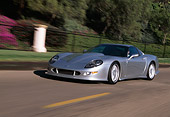 AUT 29 RK0287 18
1998 Chevrolet Callaway C12 Corvette Silver 3/4 Side View On Road In Motion By Trees