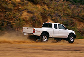 AUT 29 RK0371 08
1999 Toyota Tacoma X-Tra 4x4 White 3/4 Rear View On Dirt Road In Motion