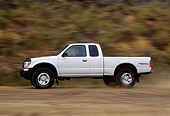 AUT 29 RK0373 04
1999 Toyota Tacoma X-Tra 4x4 White Profile View On Dirt Road In Motion