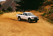 AUT 29 RK0374 08
1999 Toyota Tacoma X-Tra 4x4 White 3/4 Front View On Dirt Road In Motion