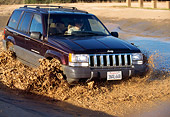AUT 29 RK0386 07
1996 Jeep Cherokee Burgundy Front 3/4 View In Motion Through Muddy Water
