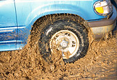 AUT 29 RK0394 02
1996 Ford Explorer Blue Close Up Of Moving Tire In Mud