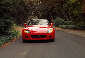 AUT 29 RK0467 07
2000 Honda S2000 Convertible Red Head On View On Road In Motion By Trees