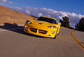 AUT 29 RK0479 04
1996 Dodge Hennessey Viper Venom 650R Yellow In Motion On Road Slanted 3/4 Front View Dry Grass Hill Blue Sky
