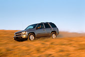 AUT 29 RK0579 02
2002 Chevy Trailblazer LTZ 4WD Pewter 3/4 Side View On Road In Motion By Dry Grass Blue Sky