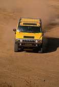 AUT 29 RK0623 04
2003 GM H2 Hummer Yellow Head On Dirt Road Making Dust