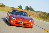AUT 29 RK0856 01
2005 Dodge Viper SRT10 Convertible Copper Head Orange 3/4 Front View On Road In Motion