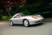 AUT 29 RK0942 01
1999 Porsche 911 Carrera Coupe Silver 3/4 Side View On Road Trees Background