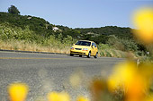 AUT 29 RK0948 01
2004 Chevy Aveo LS Yellow Low 3/4 Front View On Road In Motion By Hills