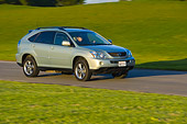AUT 29 RK1018 01
2006 Lexus RX400 Hybrid Light Green 3/4 Side View On Road In Motion By Grass