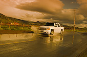 AUT 29 RK1163 01
2005 GMC Yukon XL Denali White 3/4 Front View On Wet Road In Motion