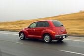 AUT 29 RK1195 01
2006 Chrysler PT Cruiser Red 3/4 Rear View On Road In Motion By Hills