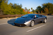 AUT 29 RK1197 01
2007 Lamborghini Murcielago LP640 Gray 3/4 Front View On Road In Motion By Trees