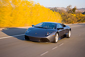 AUT 29 RK1198 01
2007 Lamborghini Murcielago LP640 Gray 3/4 Front View On Road In Motion By Trees