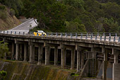 AUT 29 RK1238 01
2007 Audi RS4 Yellow Distant 3/4 Front View On Bridge In Motion