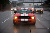 AUT 29 RK1251 01
2007 Ford Shelby Mustang GT500 Coupe Red And White Head On View On Road In Motion