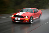 AUT 29 RK1254 01
2007 Ford Shelby Mustang GT500 Coupe Red And White 3/4 Front View On Road In Motion