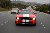 AUT 29 RK1258 02
2007 Ford Shelby Mustang GT500 Coupe Red And White Head On View On Road In Motion