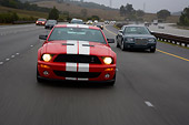 AUT 29 RK1262 01
2007 Ford Shelby Mustang GT500 Coupe Red And White Head On View On Road In Motion