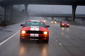 AUT 29 RK1264 01
2007 Ford Shelby Mustang GT500 Coupe Red And White Head On View On Road In Motion