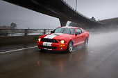 AUT 29 RK1266 01
2007 Ford Shelby Mustang GT500 Coupe Red And White 3/4 Front View On Road In Motion